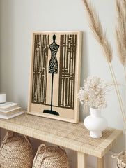 Tailor mannequin wall art with intricate maze patterns in dark brown and cream, graphic, in an alternate framed mockup
