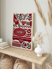 Illustrative tea time art print with red tulips, teacups, and a circular table motif on a, in an alternate framed mockup