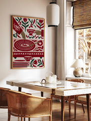 Illustrative tea time art print with red tulips, teacups, and a circular table motif on a cream, in a styled room mockup