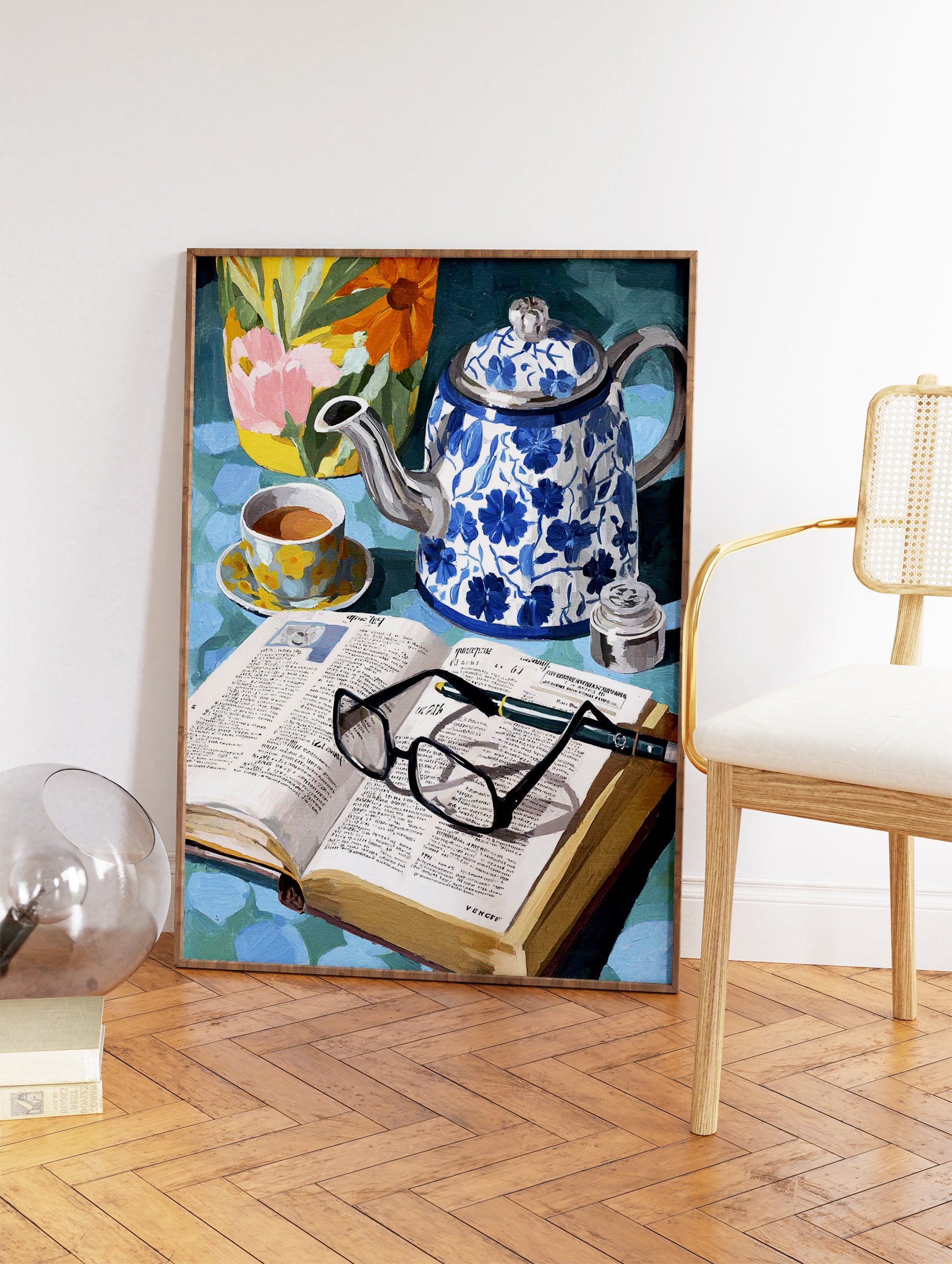 Still life painting with blue floral teapot, teacup, open book with glasses, and a vibrant floral vase. - Image 2