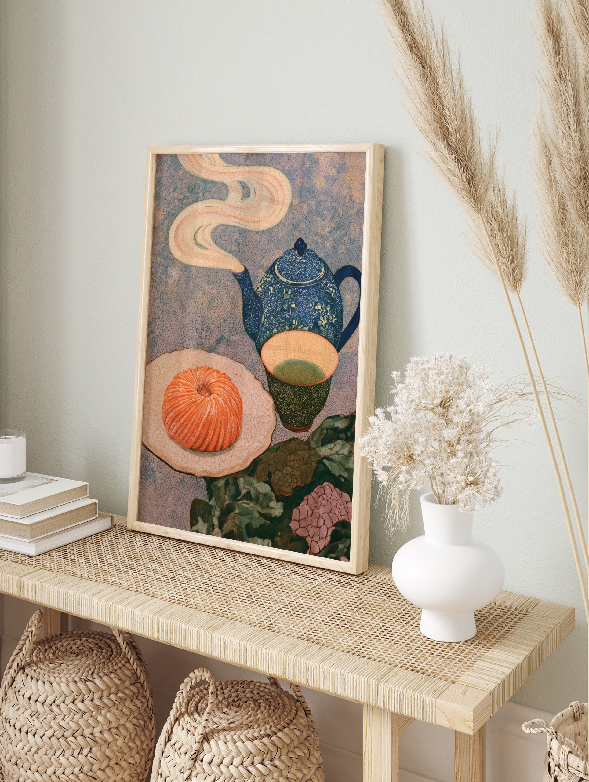 Still life art print with a blue teapot, green tea, and a swirled orange pastry on a textured, in an alternate framed mockup