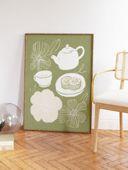 Sage green tea time wall art illustration with a white teapot, teacup, two mooncakes, and white and light pink flowers. - Image 2