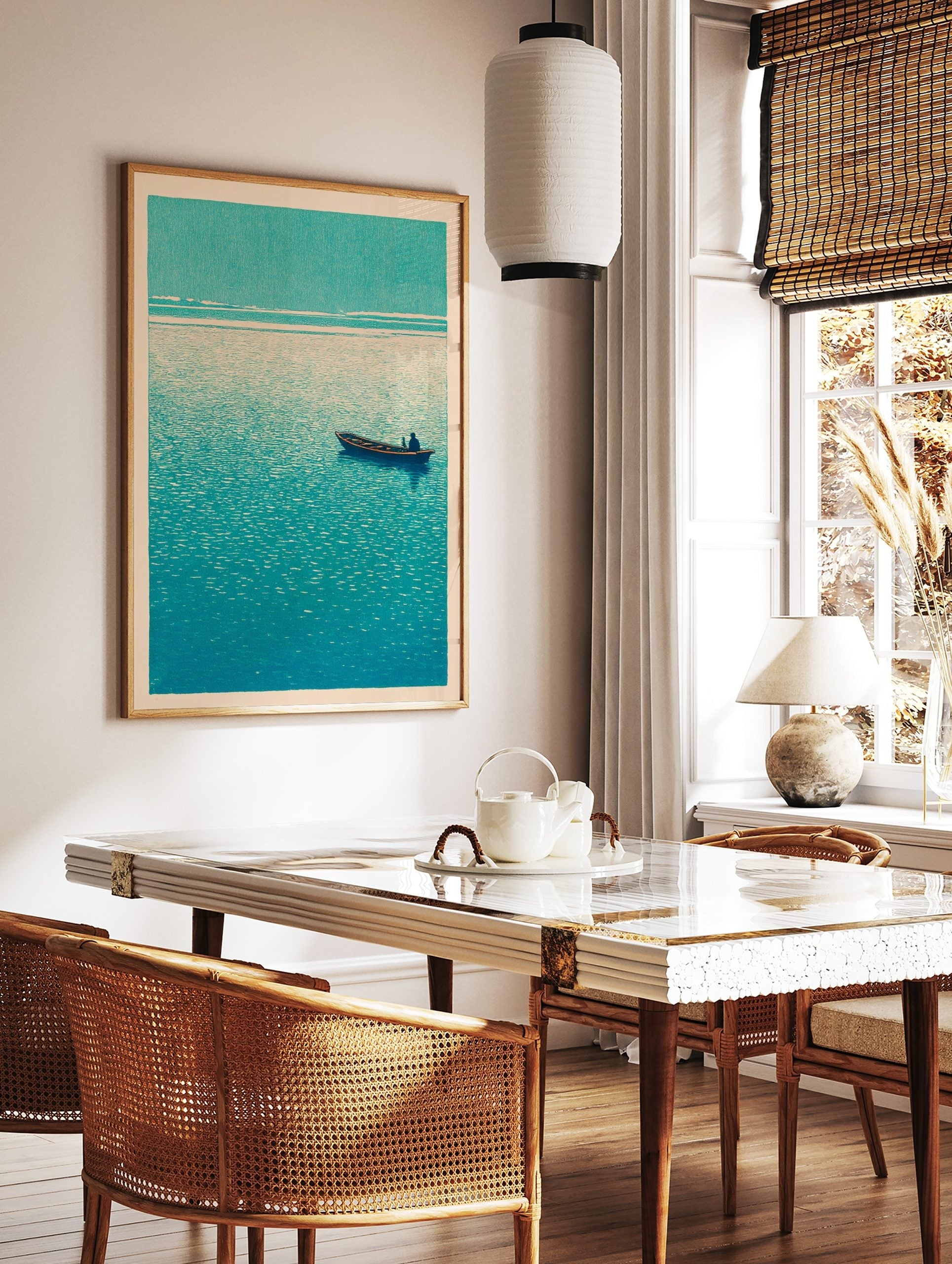 Minimalist teal boat print with a single figure on calm, textured water under a light sky, in a styled room mockup