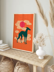 Teal greyhound silhouette against an orange background with a pink sun and stylised white, in an alternate framed mockup