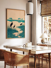 Teal heron wetland art print with three birds, tall grasses, and stylised swirling water patterns, in a styled room mockup