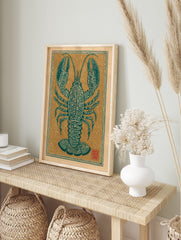 Teal lobster illustration with ornate patterns, centered on a beige background with a, in an alternate framed mockup