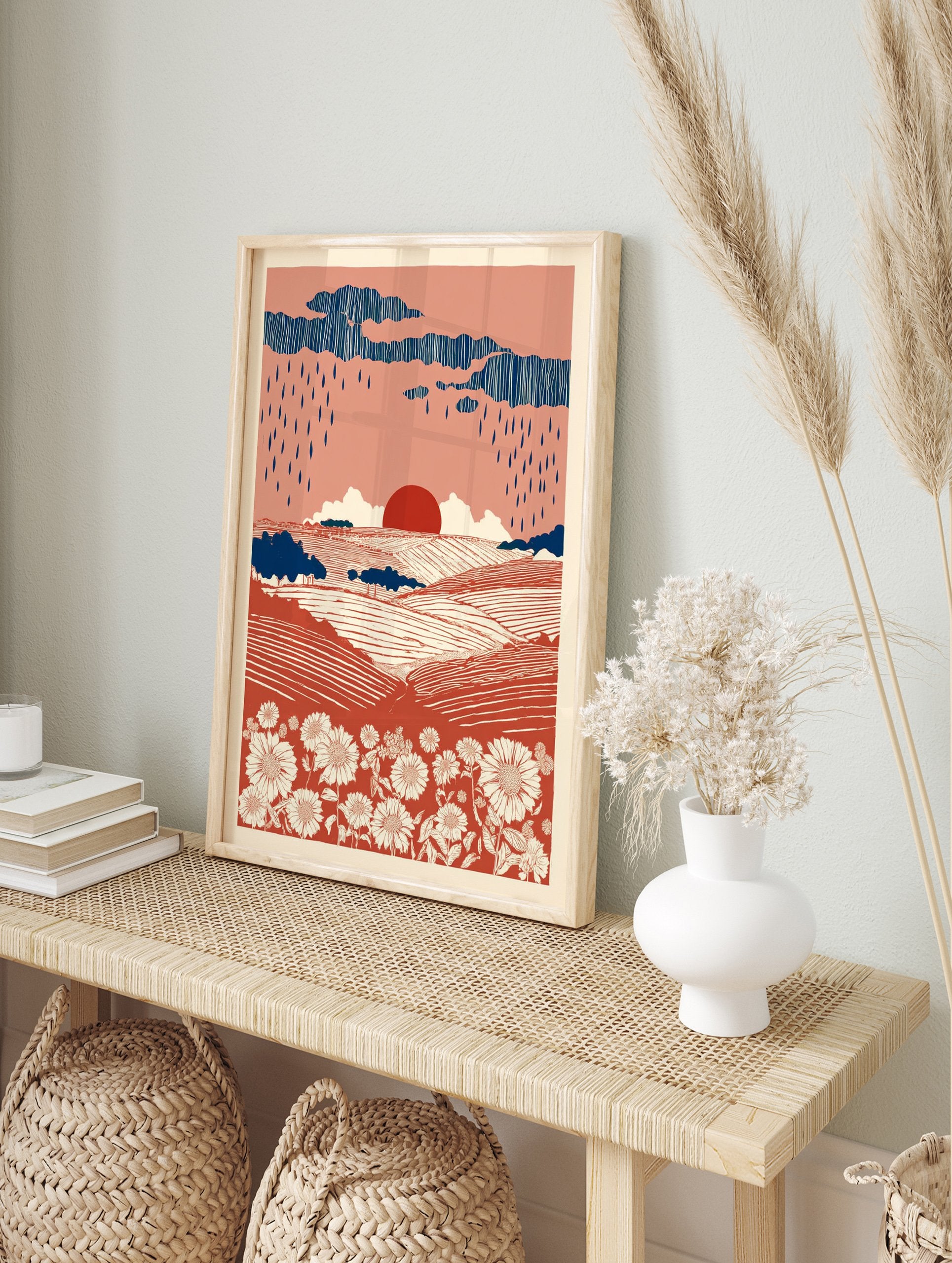 Terracotta landscape wall art print with rolling fields, white flowers, dark blue rain clouds, and a red sun. - Image 3