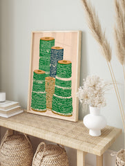 Illustrative textile spool wall art print showing stacks of green, blue, and brown spools on a light background. - Image 3