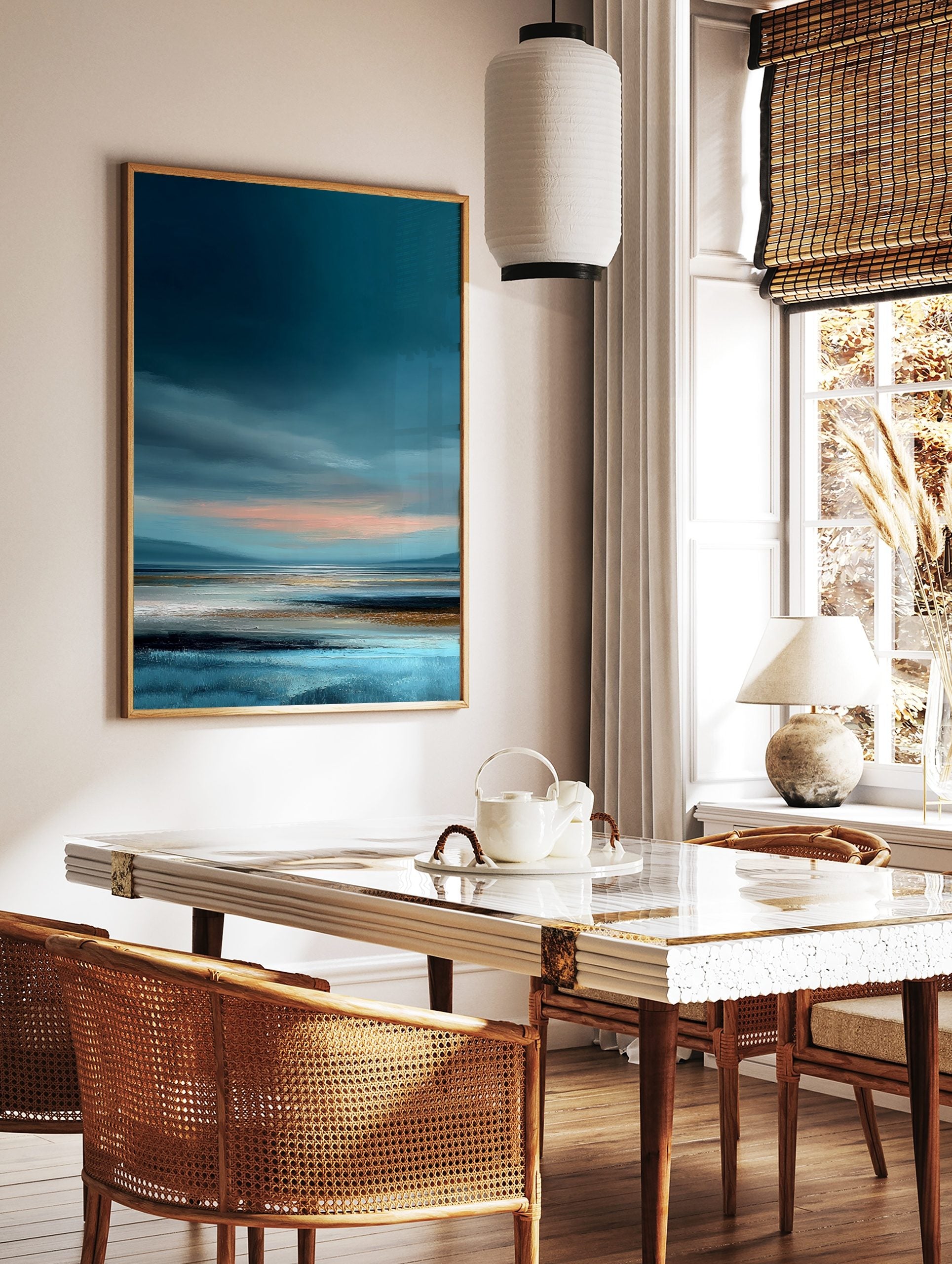 Abstract coastal landscape painting with deep blue sky, peach horizon, and textured tidal flats in, in a styled room mockup