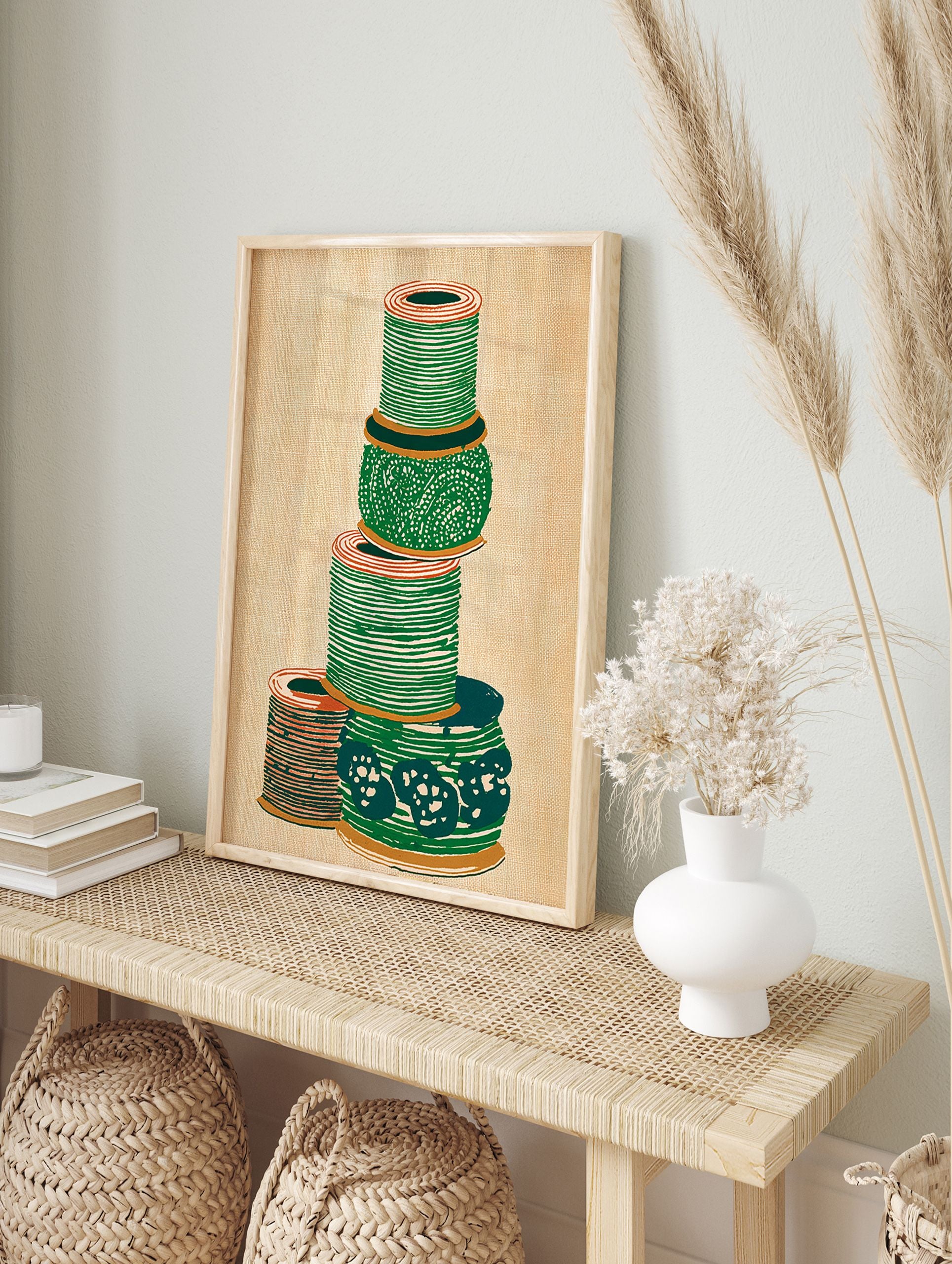 Illustrated green and orange thread spool wall art stacked on a textured beige background. - Image 3