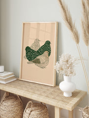 Illustrative wall art print with three stylised birds in dark green and beige, showing, in an alternate framed mockup