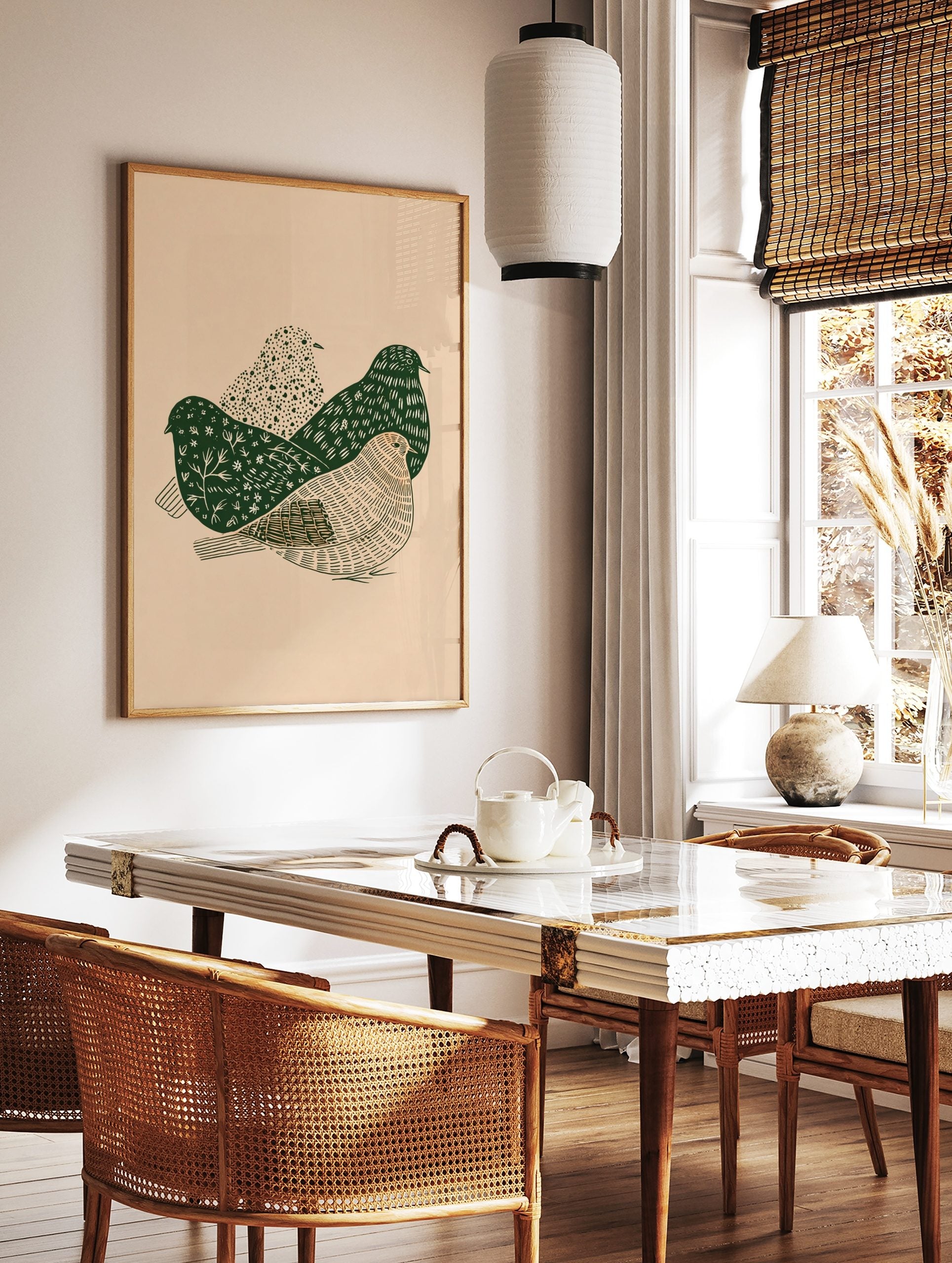 Illustrative wall art print with three stylised birds in dark green and beige, showing various, in a styled room mockup