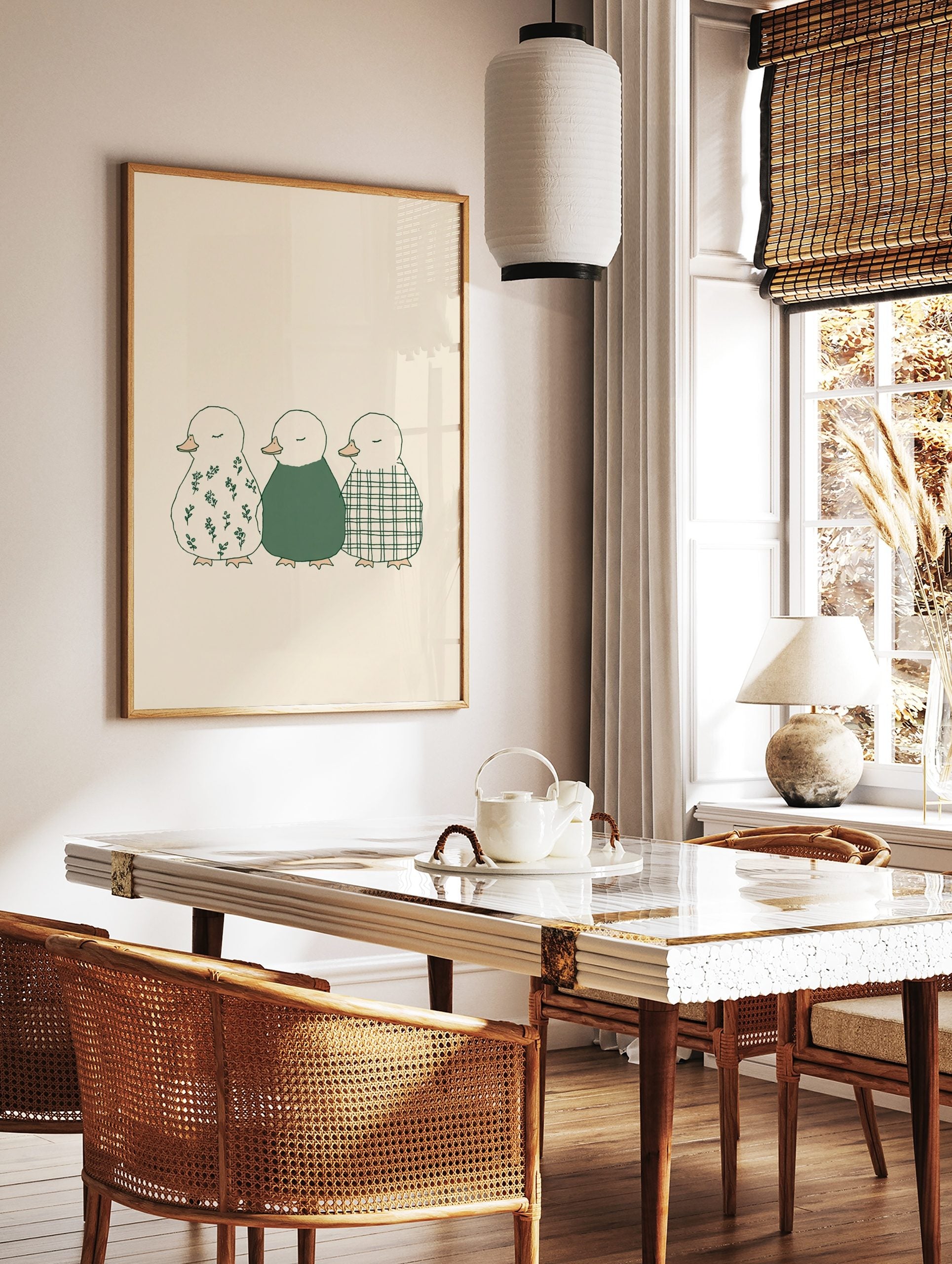 Illustration of three ducklings in a row, with floral, solid green, and plaid patterns on a beige, in a styled room mockup