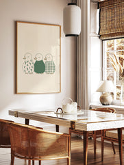 Illustration of three ducklings in a row, with floral, solid green, and plaid patterns on a beige, in a styled room mockup