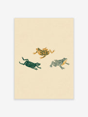 Three illustrative frogs with floral, solid, and striped patterns in green and gold on a beige background