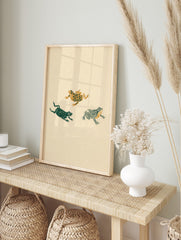 Three illustrative frogs with floral, solid, and striped patterns in green and gold on a, in an alternate framed mockup