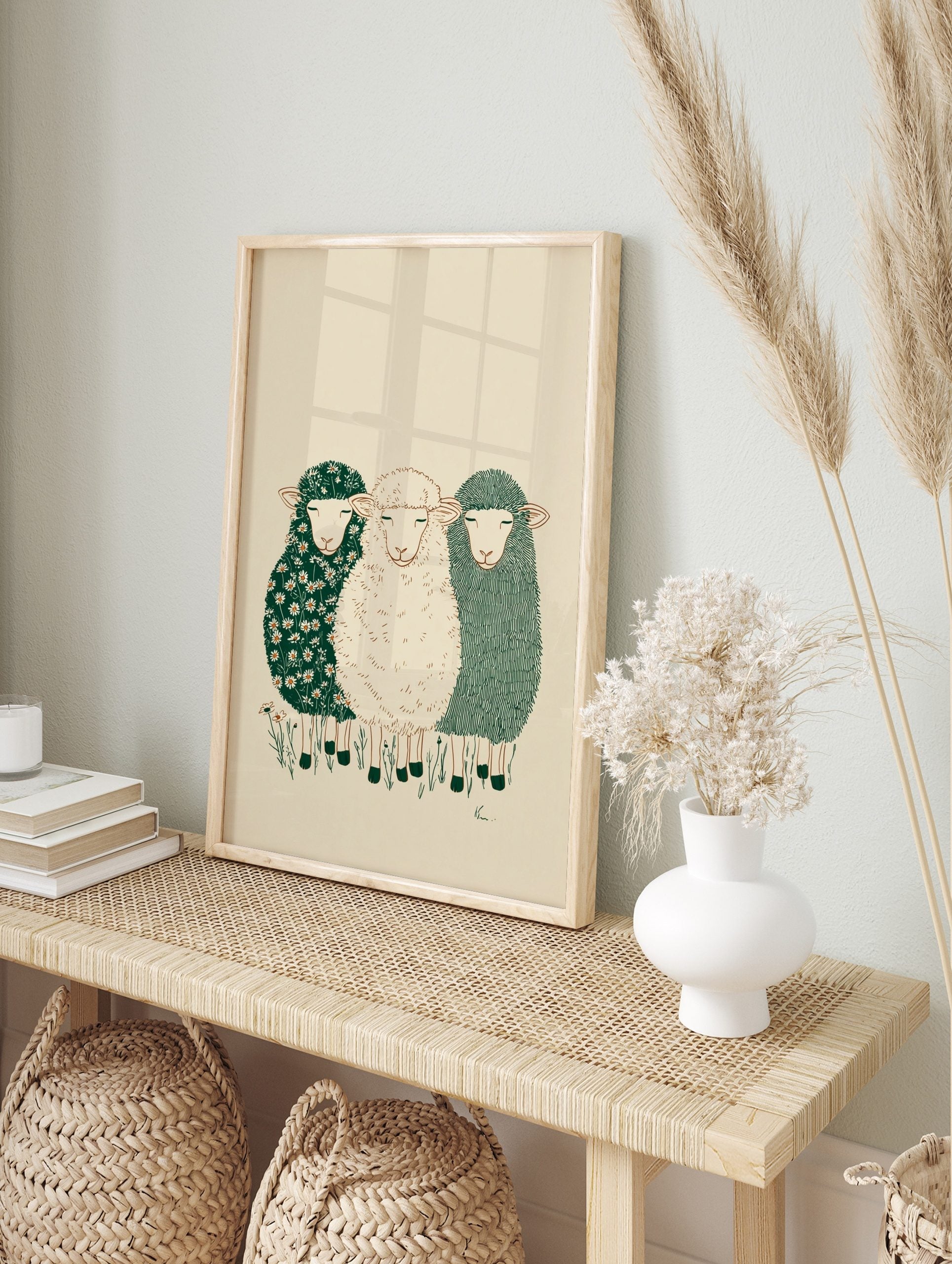 Illustrative wall art of three peaceful sheep with different textured fleeces on a beige, in an alternate framed mockup