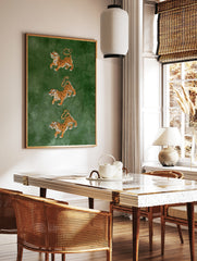 Three tigers in leaping poses on a deep green background, illustrative wildlife art print, in a styled room mockup