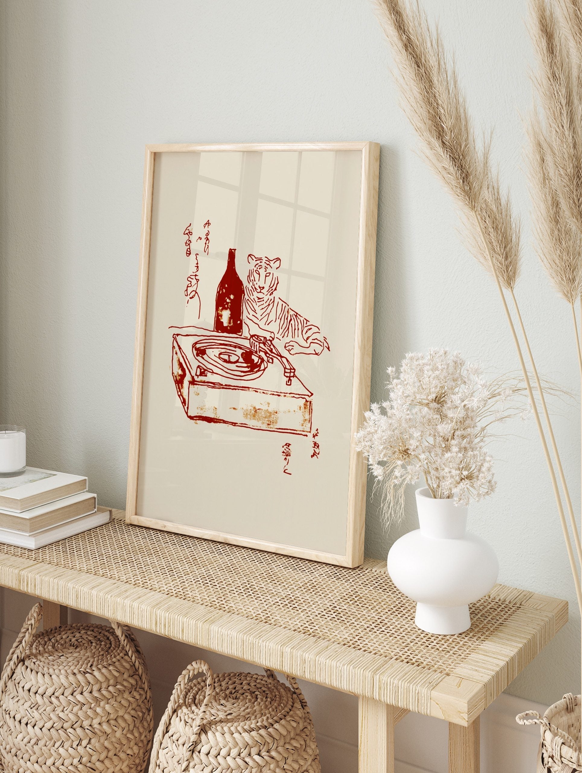Red line art of a tiger, bottle, and turntable with Japanese calligraphy on a beige background, in an alternate framed mockup