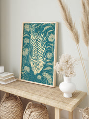 Stylized tiger and chrysanthemum flower illustration on teal background in a woodcut print, in an alternate framed mockup