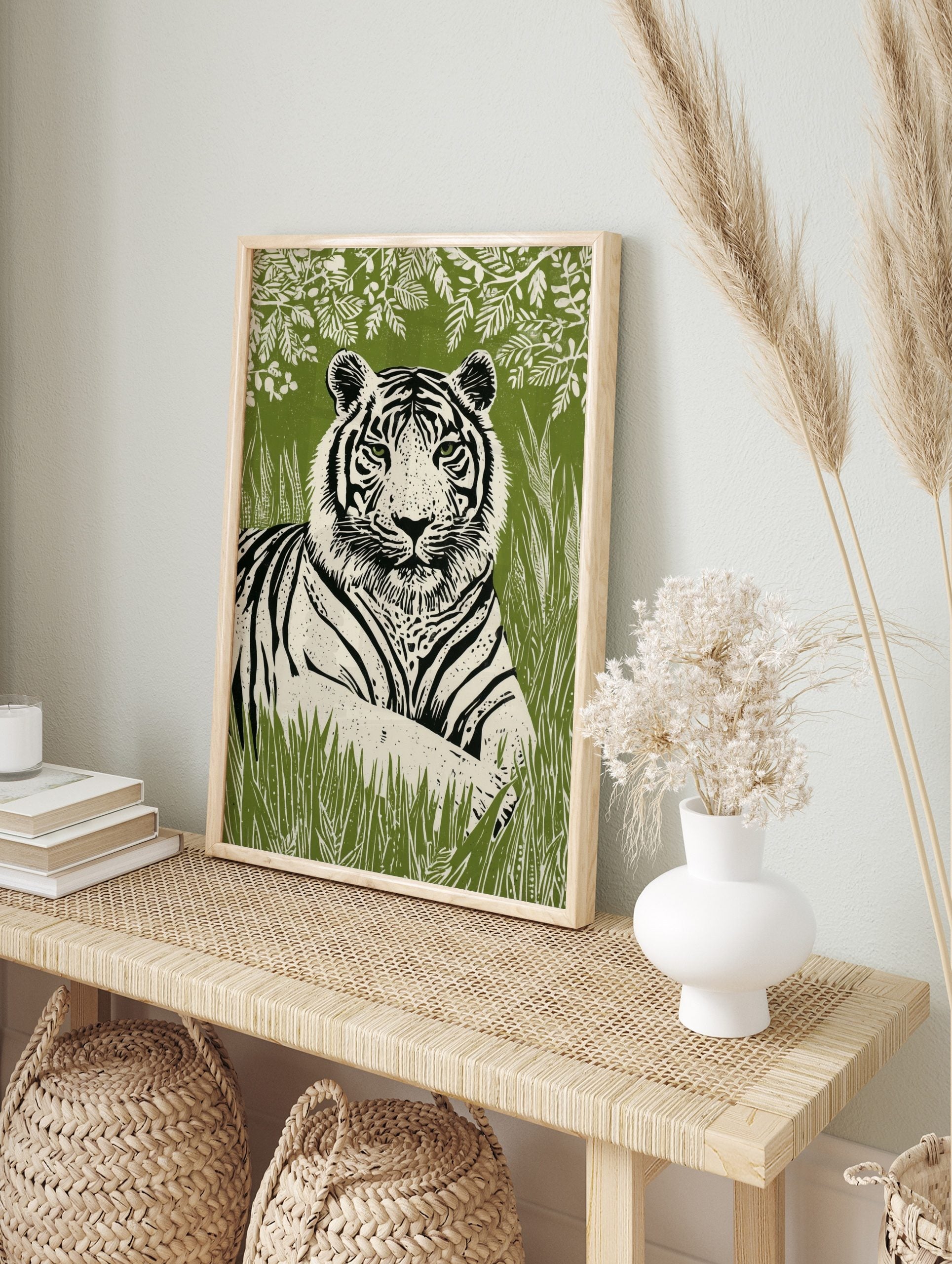 Linocut-style tiger wall art print with green eyes, black stripes, and white fur, against a, in an alternate framed mockup