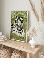 Linocut-style tiger wall art print with green eyes, black stripes, and white fur, against a, in an alternate framed mockup