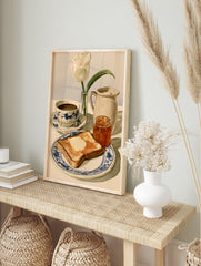 Watercolor illustration of breakfast with toast, marmalade, coffee, and a white tulip on a, in an alternate framed mockup