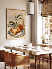 Watercolor illustration of breakfast with toast, marmalade, coffee, and a white tulip on a blue and, in a styled room mockup