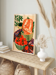 Still life illustration of tomatoes on the vine, bread, and olives in a colourful kitchen, in an alternate framed mockup
