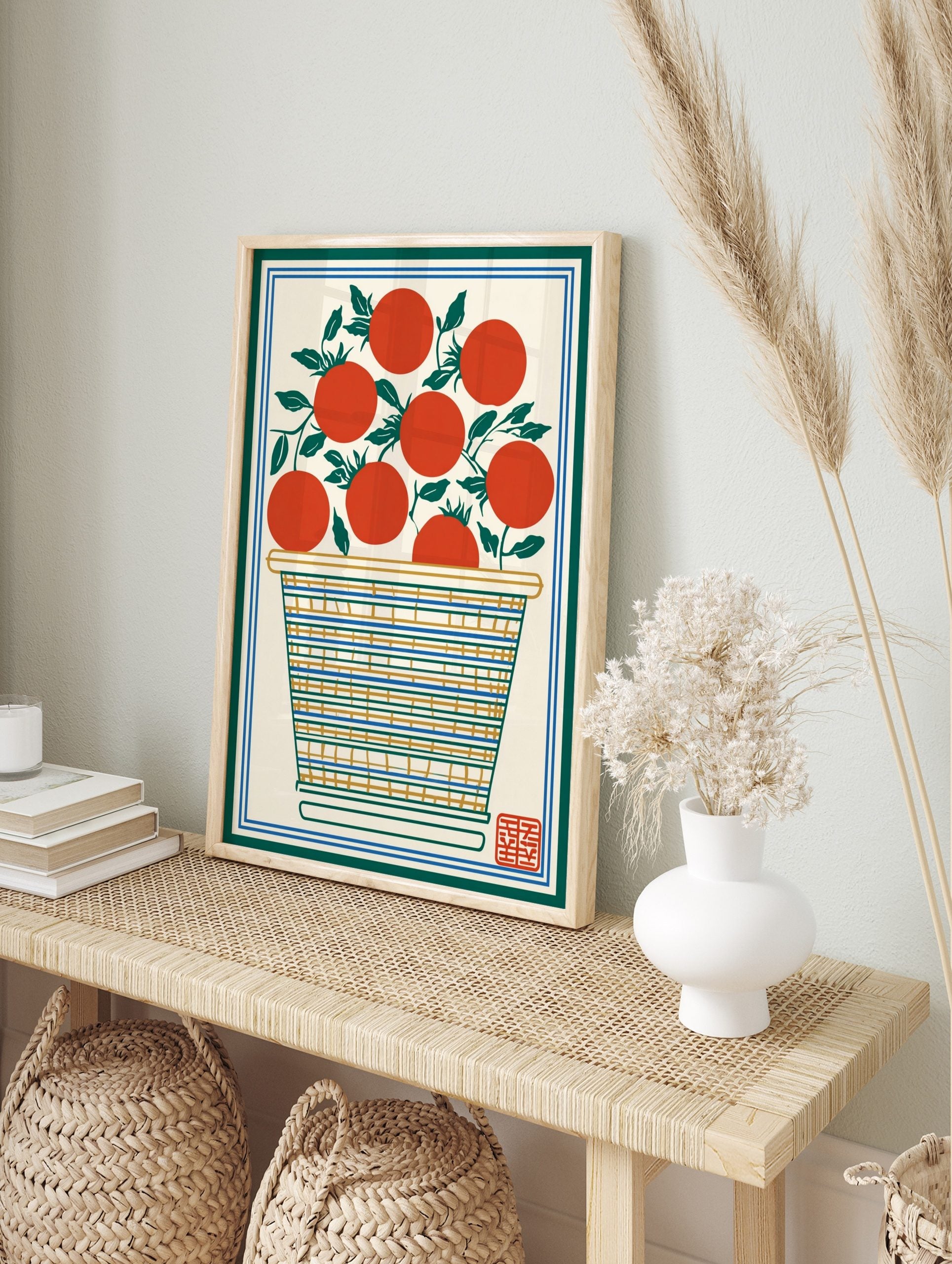 Illustrative print of red tomatoes with green leaves in a striped basket, framed by green and, in an alternate framed mockup