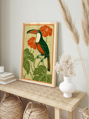 Art Nouveau style illustration of a toucan bird with green body, orange chest, red flowers, in an alternate framed mockup