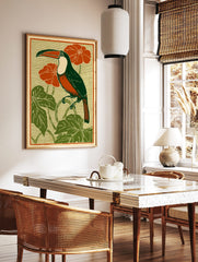 Art Nouveau style illustration of a toucan bird with green body, orange chest, red flowers, and, in a styled room mockup