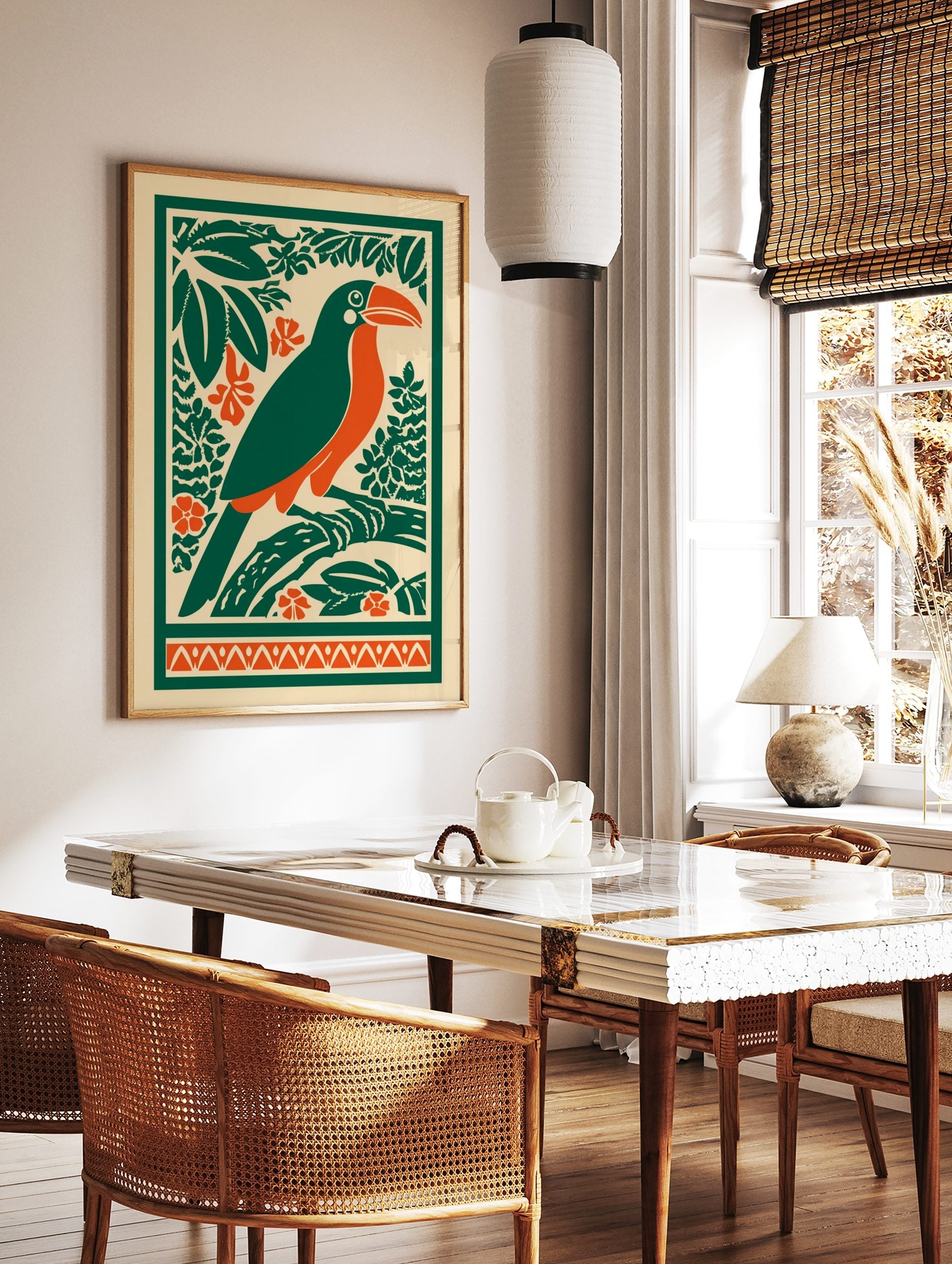 Illustrative toucan bird print with orange beak, green body, tropical leaves, and orange flowers on, in a styled room mockup