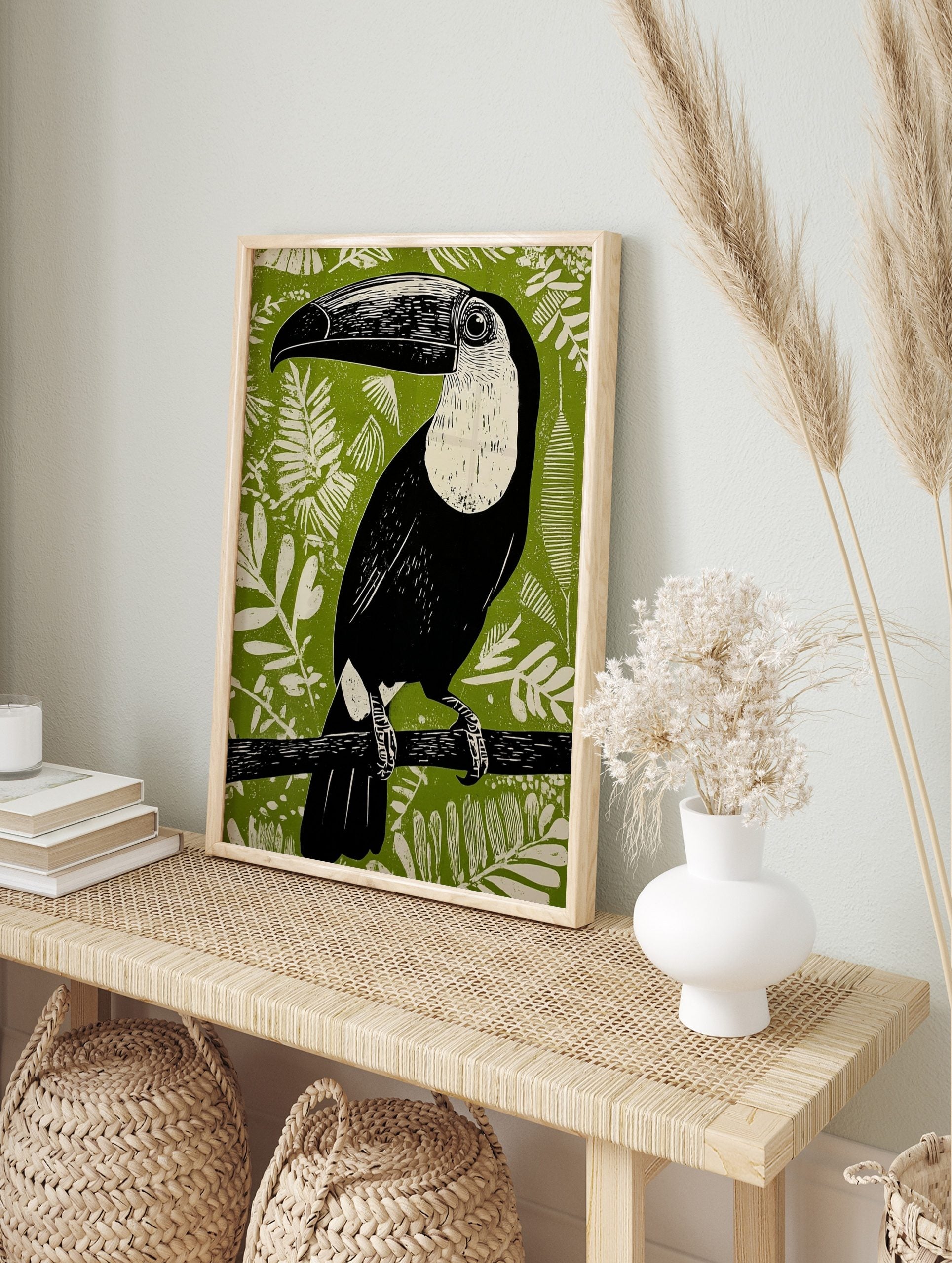 Black and white Toucana toucan linocut art print on a vibrant green jungle foliage, in an alternate framed mockup