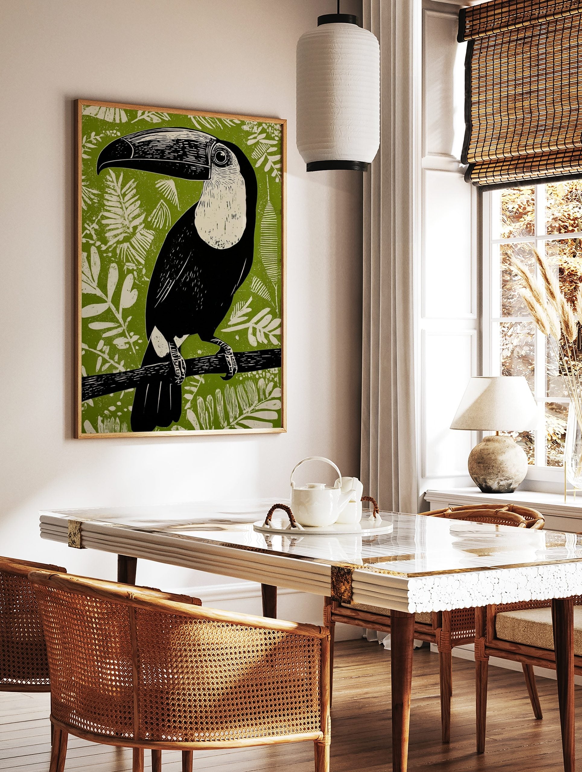 Black and white Toucana toucan linocut art print on a vibrant green jungle foliage background, in a styled room mockup