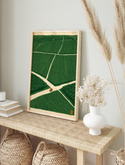 Orange tractor driving on a crossroad in a vast green field, illustrative minimalist wall art, in an alternate framed mockup