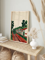 Vintage style Train Station Art print with a green train on red tracks next to a station building and trees. - Image 3