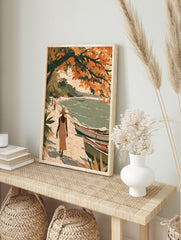Illustrated tropical beach scene with a figure in a sun hat, boats on sand, and orange, in an alternate framed mockup