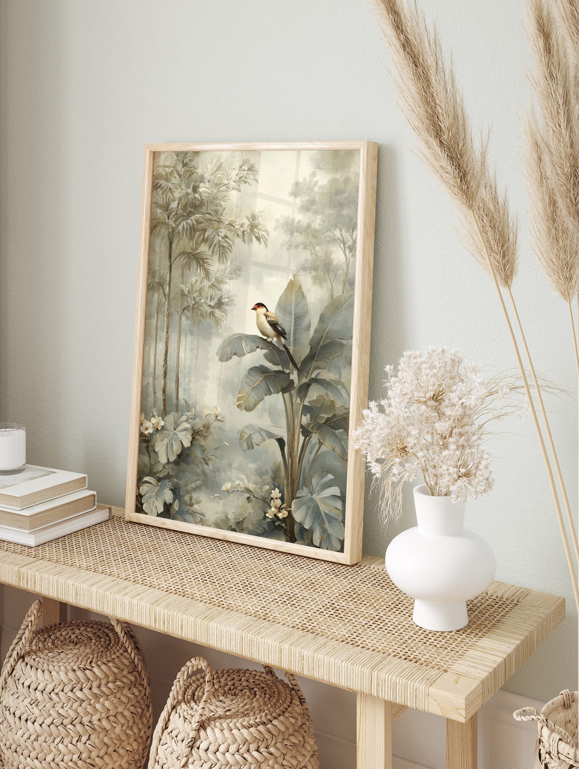 Tropical bird with red head perched on large banana leaf in muted jungle foliage art print, in an alternate framed mockup