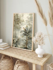 Tropical bird with red head perched on large banana leaf in muted jungle foliage art print, in an alternate framed mockup