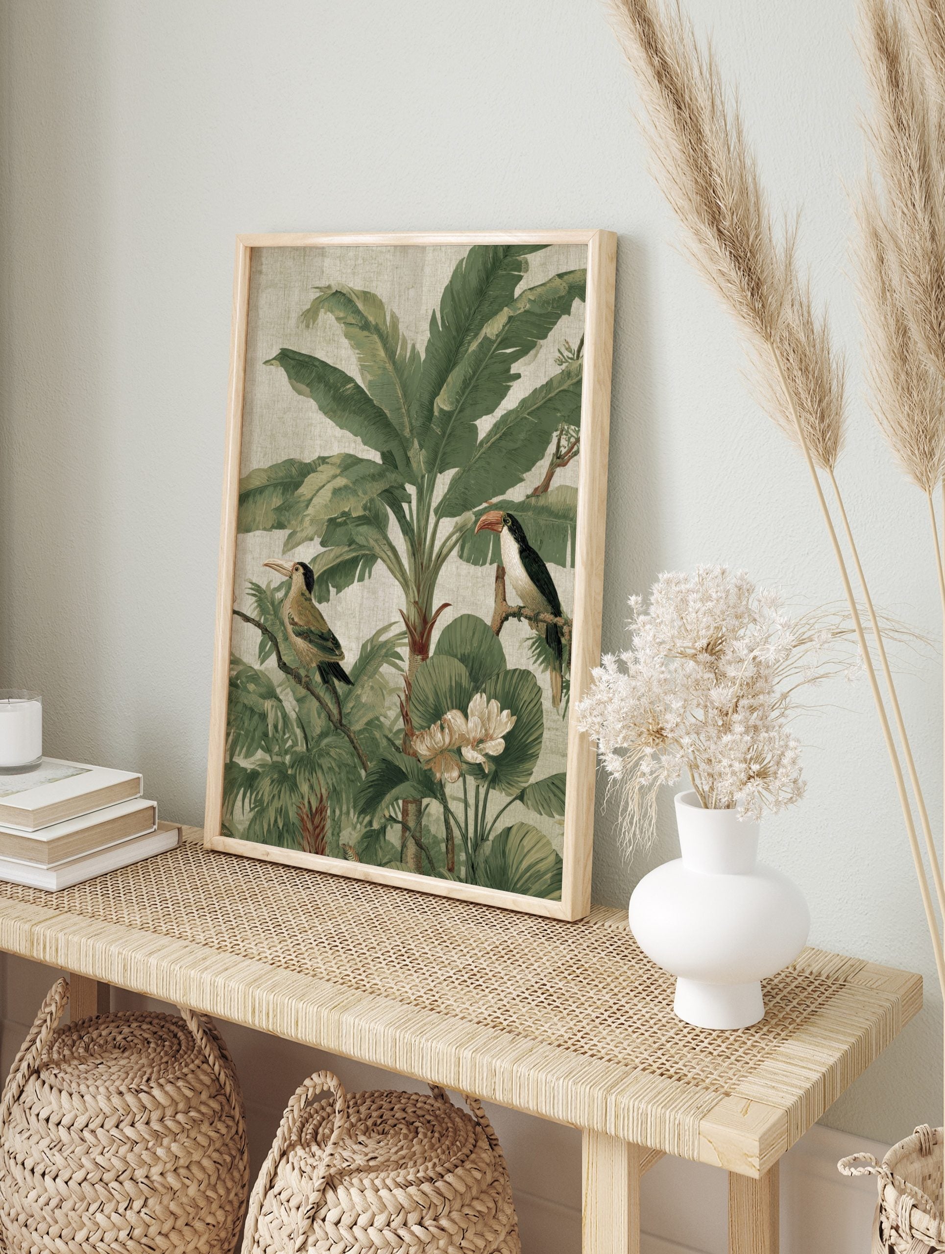 Tropical jungle illustration with a toucan, another bird, large banana leaves, and white, in an alternate framed mockup