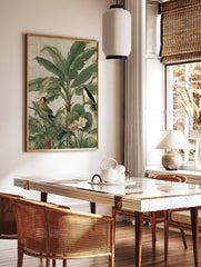 Tropical jungle illustration with a toucan, another bird, large banana leaves, and white flowers on, in a styled room mockup