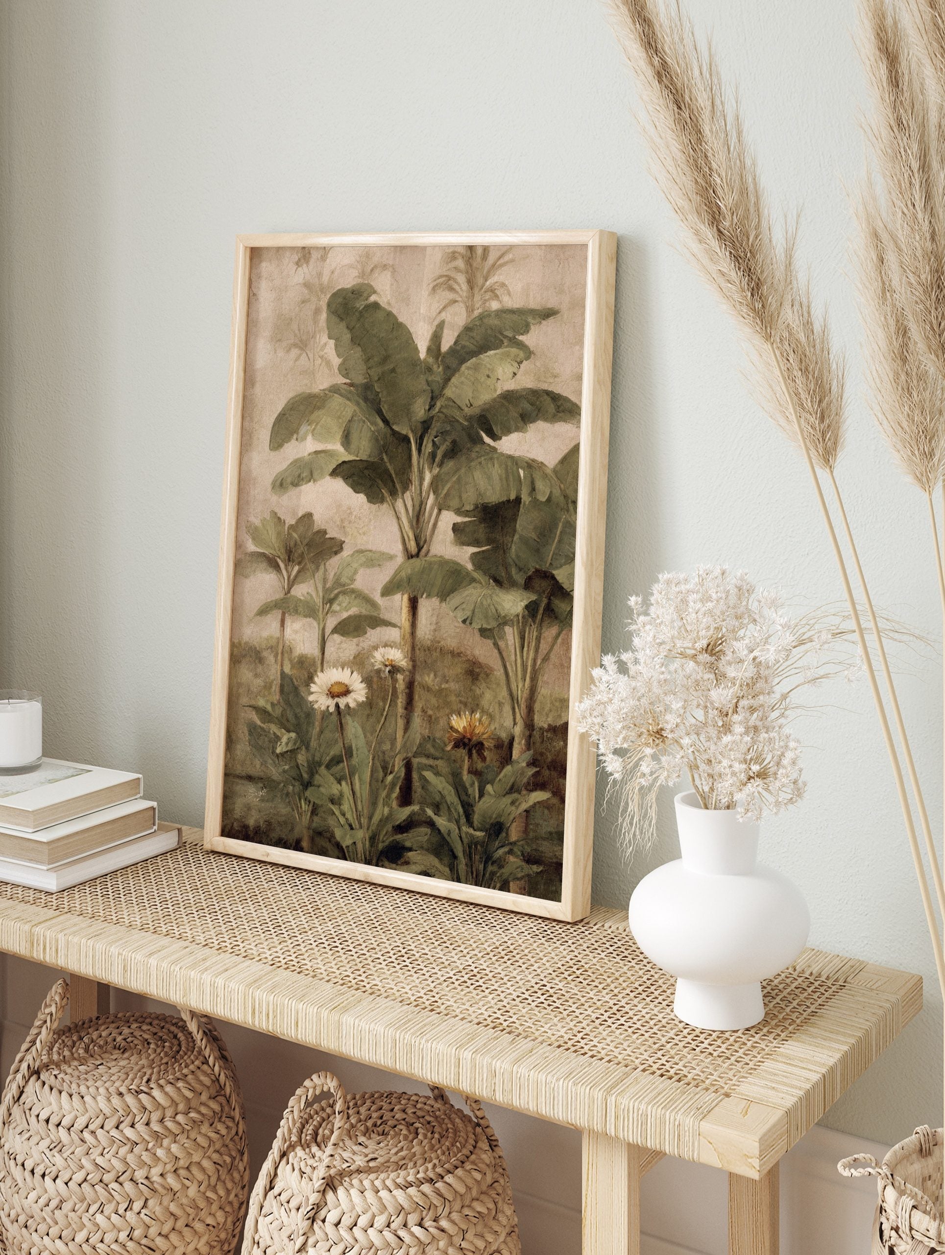 Tropical botanical painting with green banana leaves, palm trees, white daisies, and yellow, in an alternate framed mockup