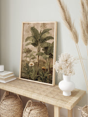 Tropical botanical painting with green banana leaves, palm trees, white daisies, and yellow, in an alternate framed mockup