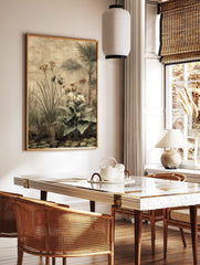 Botanical art print of a tropical garden with palm trees, tall grasses, and flowering plants over, in a styled room mockup