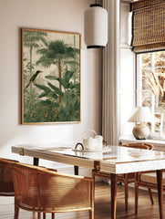 Tropical jungle wall art with a bird, palm trees, and lush green botanical foliage illustration, in a styled room mockup