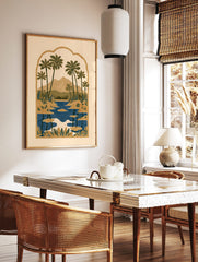 Illustrative tropical landscape print with palm trees, mountains, and a lake inside an ornate, in a styled room mockup