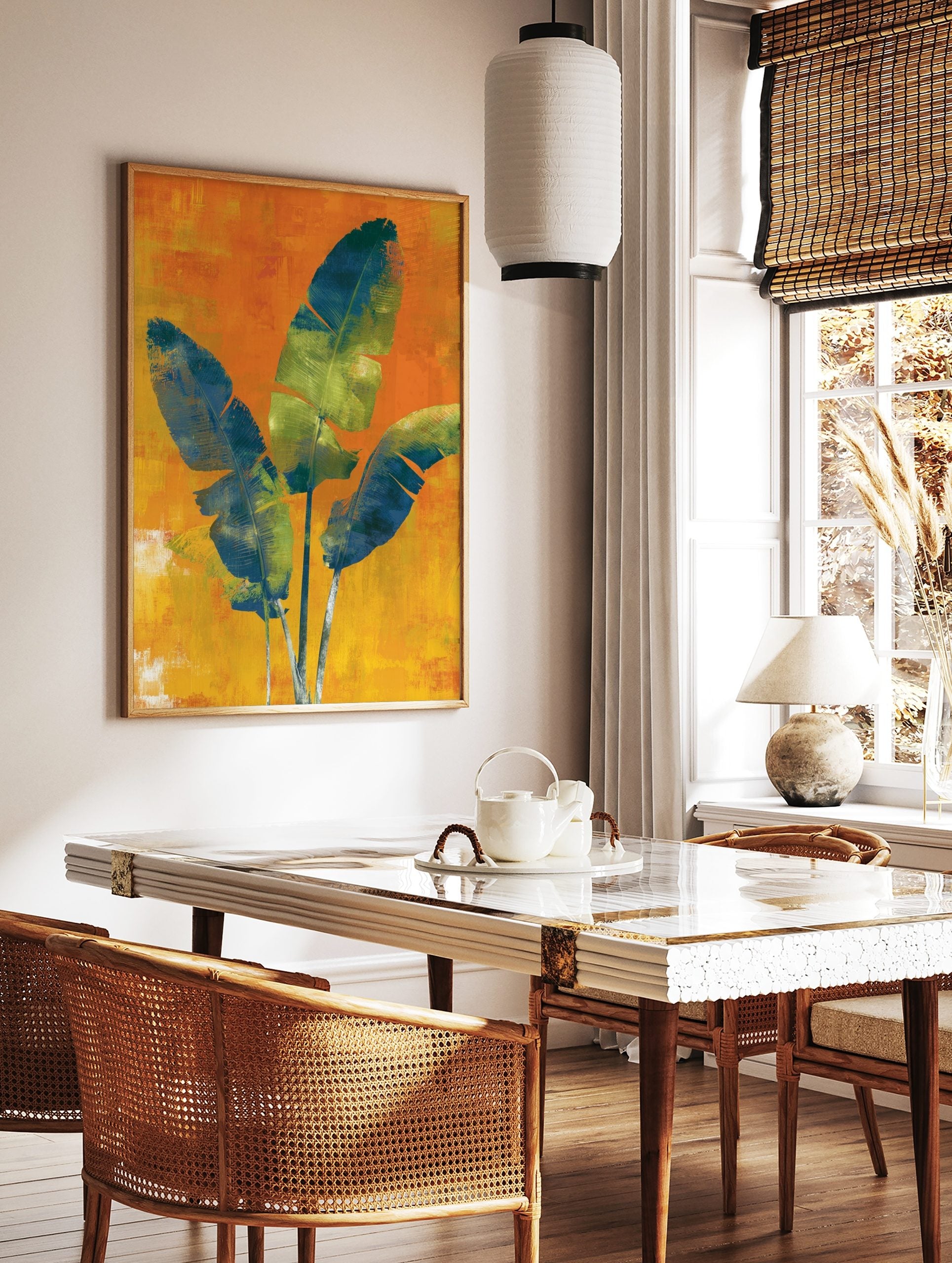 Three large blue and green tropical leaves on a textured orange and yellow background wall art print, in a styled room mockup
