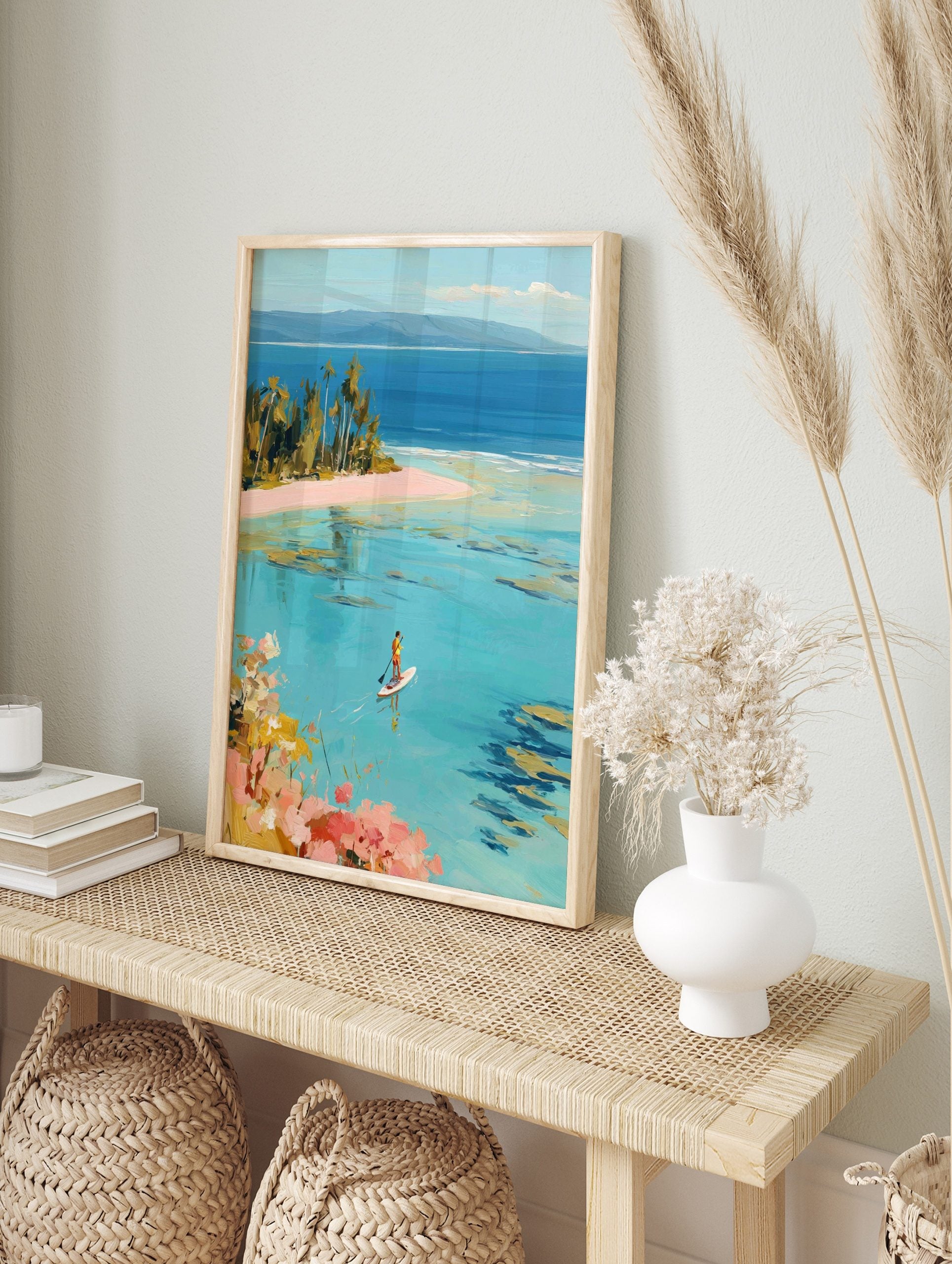 Painterly tropical beach scene with a person paddleboarding on clear turquoise water and palm, in an alternate framed mockup