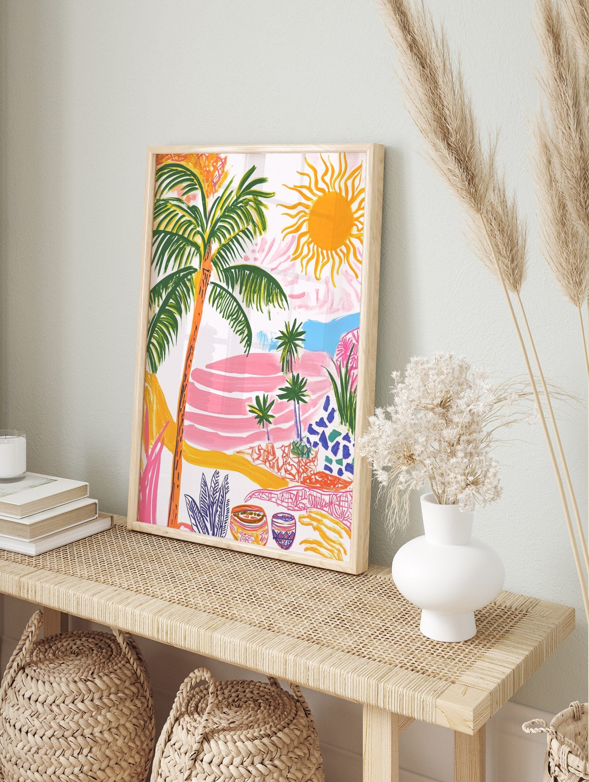 Colourful tropical landscape art print with palm trees, bright sun, pink terraced hills, and, in an alternate framed mockup